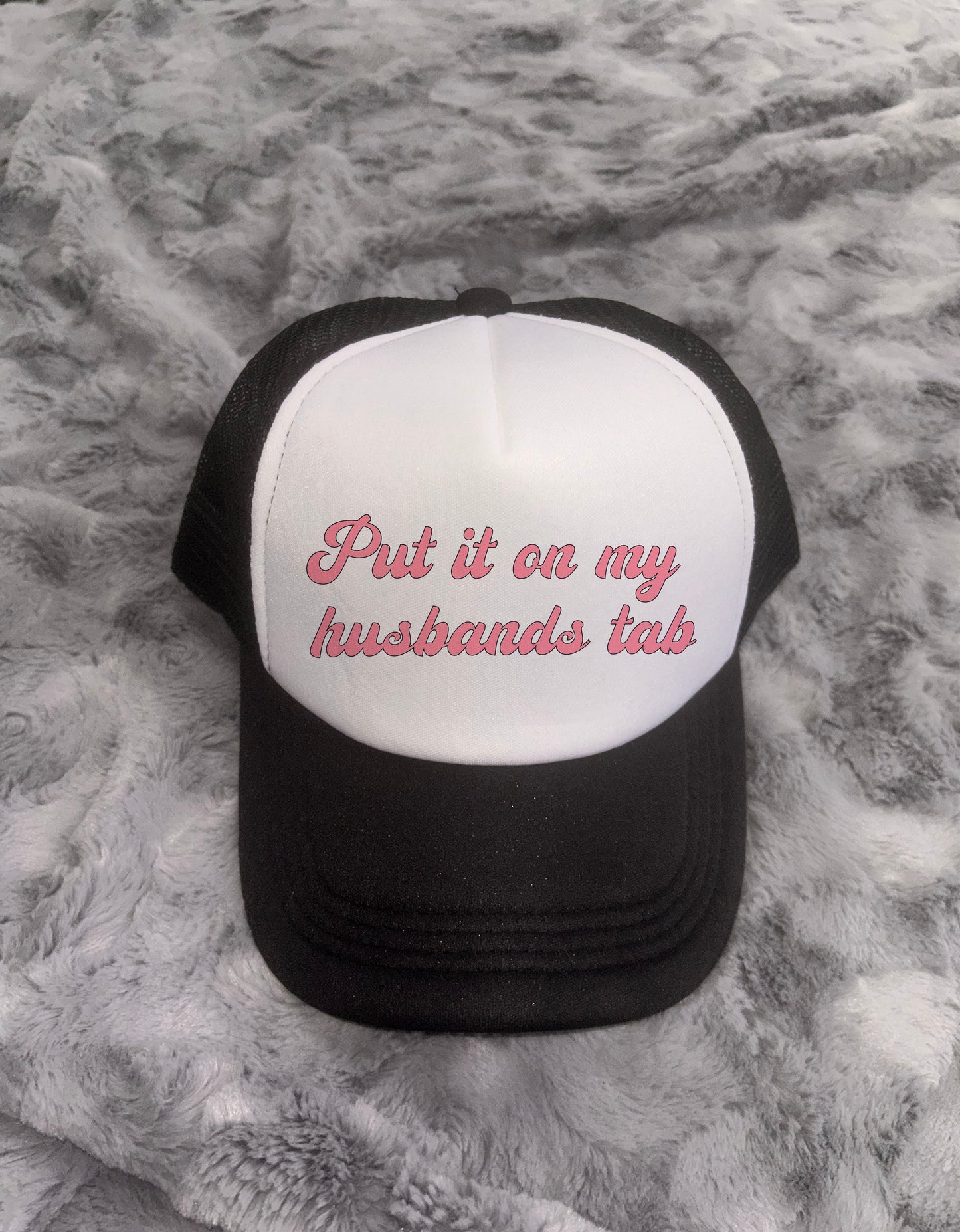 Put It On My Husbands Tab Trucker Hat