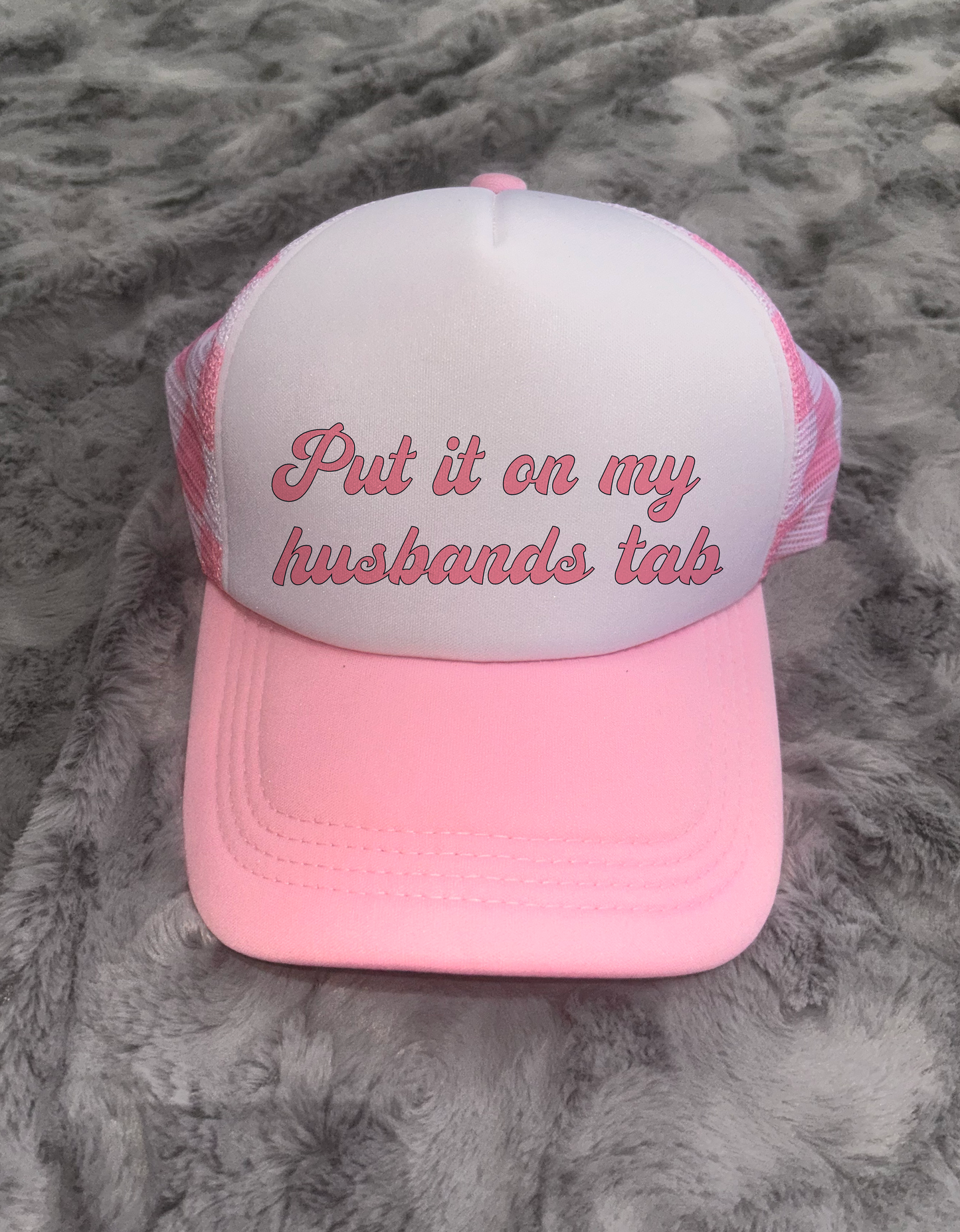 Put It On My Husbands Tab Trucker Hat